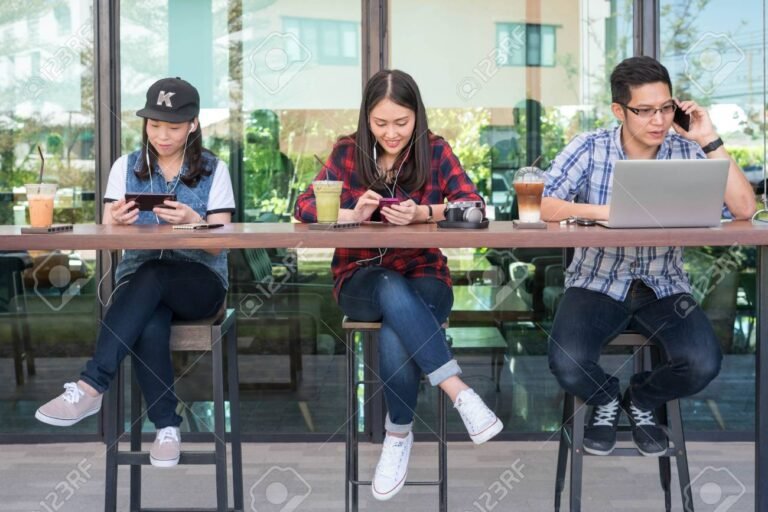 persone con smartphone e laptop in caffe
